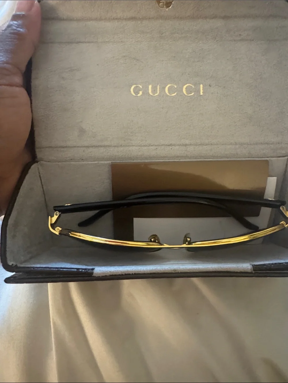 Gucci Black Frame Sunglasses with Gold Brow Bar